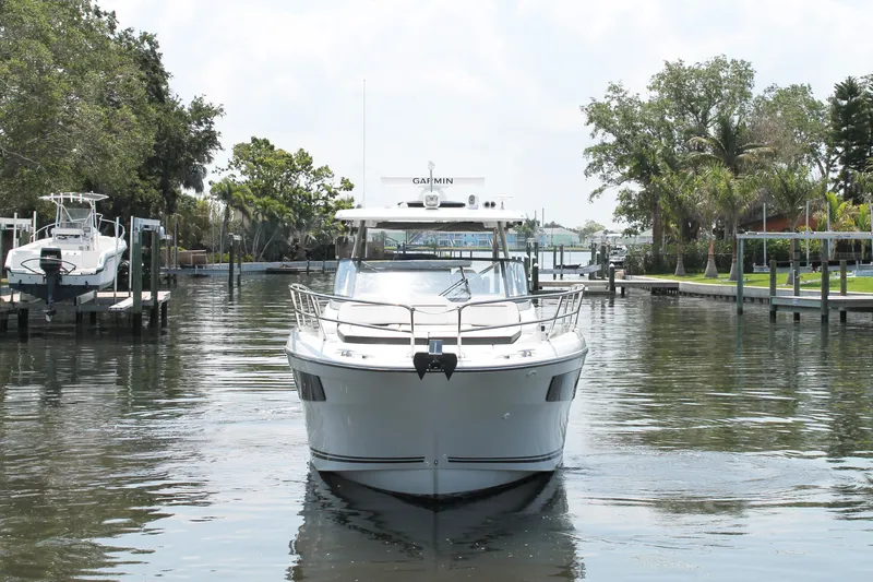 Over Exposed Yacht Photos Pics 2021 Jeanneau Leader 10.5 boat docked in a serene marina setting.