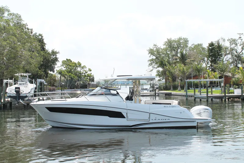 Over Exposed Yacht Photos Pics 2021 Jeanneau Leader 10.5 boat docked in a serene marina setting.