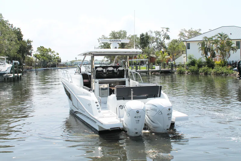 Over Exposed Yacht Photos Pics 2021 Jeanneau Leader 10.5 boat cruising on a calm canal with lush greenery.