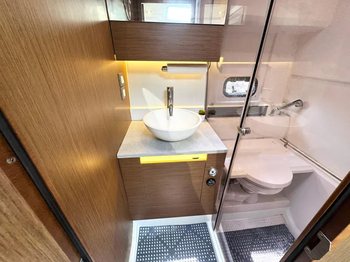 Over Exposed Yacht Photos Pics Modern bathroom in 2021 Jeanneau Leader 10.5 yacht with sleek sink and compact toilet.