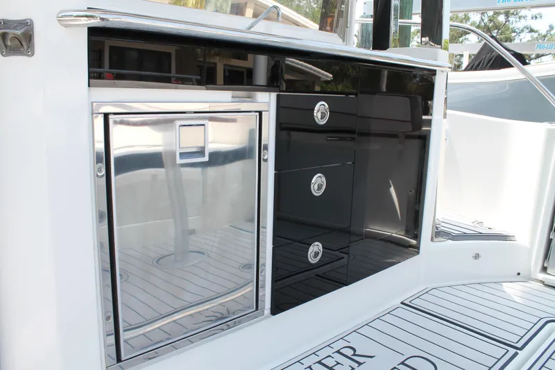 Over Exposed Yacht Photos Pics 2021 Jeanneau Leader 10.5 boat interior with sleek cabinetry and stainless steel accents.