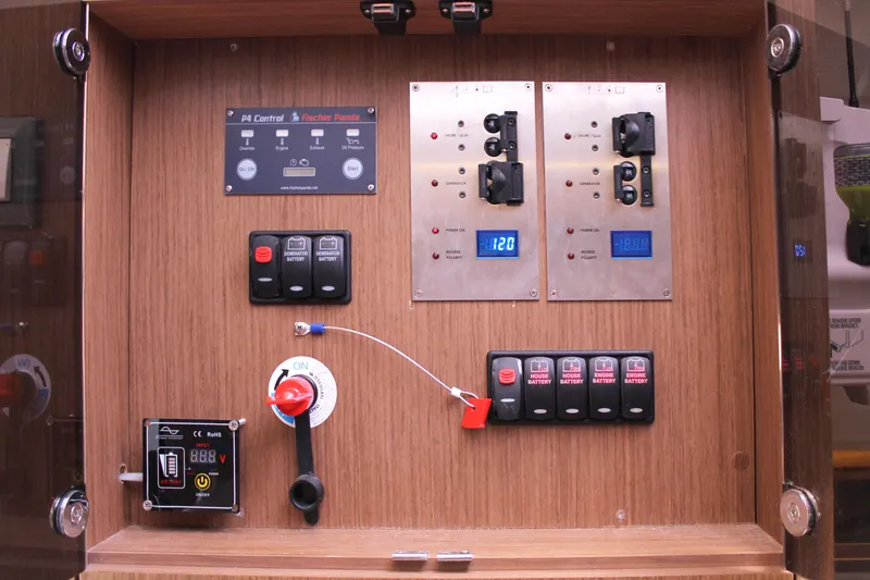 Over Exposed Yacht Photos Pics Control panel of a 2021 Jeanneau Leader 10.5 boat with switches and digital displays.