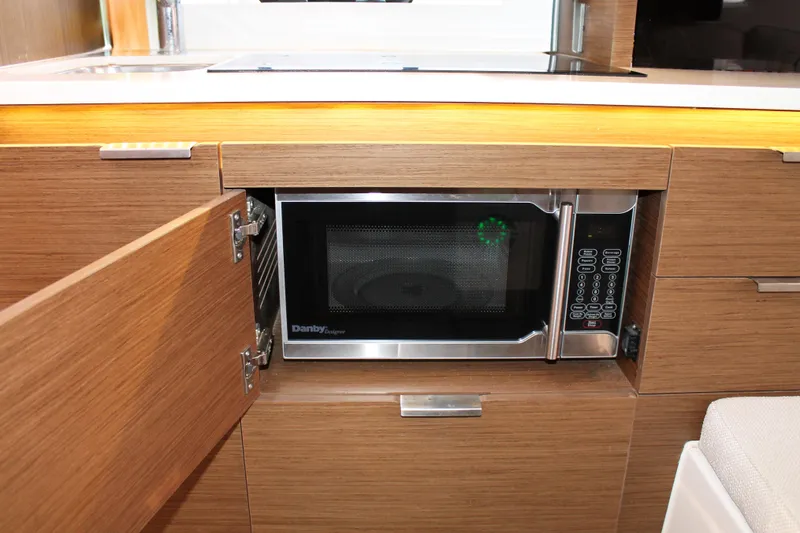 Over Exposed Yacht Photos Pics Modern kitchen area in 2021 Jeanneau Leader 10.5 with built-in microwave.