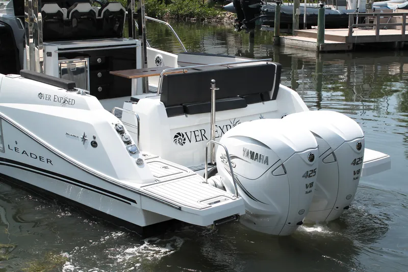 Over Exposed Yacht Photos Pics 2021 Jeanneau Leader 10.5 boat with twin Yamaha 425 engines docked in water.