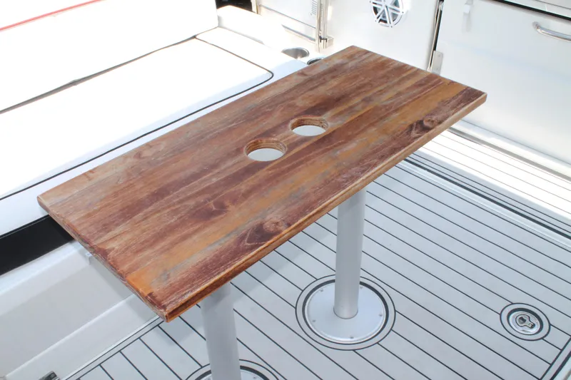 Over Exposed Yacht Photos Pics Wooden table on Jeanneau Leader 10.5 boat deck, 2021 model, with two cup holders.