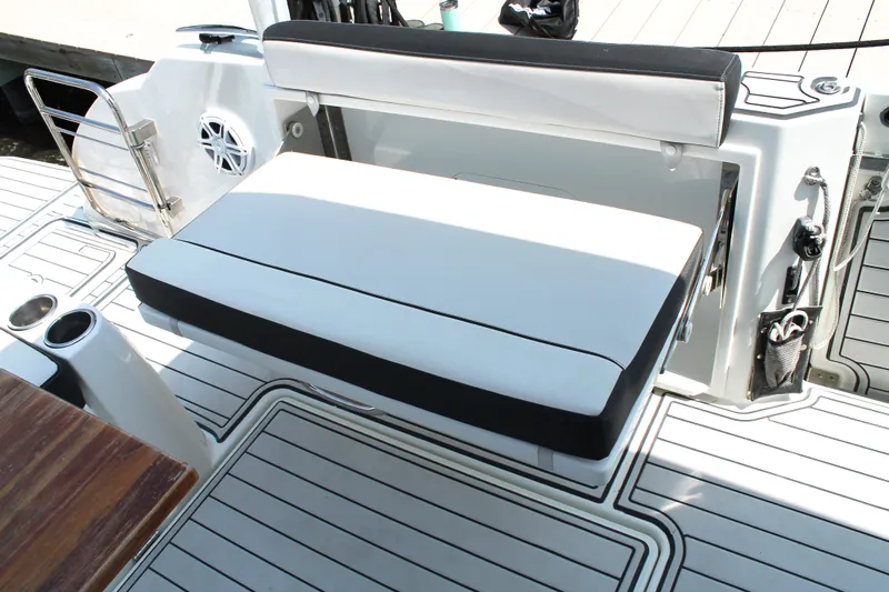 Over Exposed Yacht Photos Pics 2021 Jeanneau Leader 10.5 boat seating area with white cushions and sleek design.