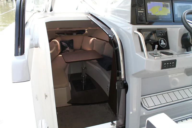 Over Exposed Yacht Photos Pics 2021 Jeanneau Leader 10.5 cabin interior with seating and navigation controls.