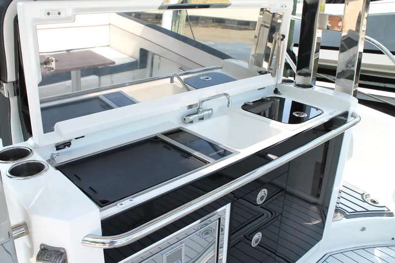 Over Exposed Yacht Photos Pics 2021 Jeanneau Leader 10.5 boat kitchen area with sink and storage compartments.