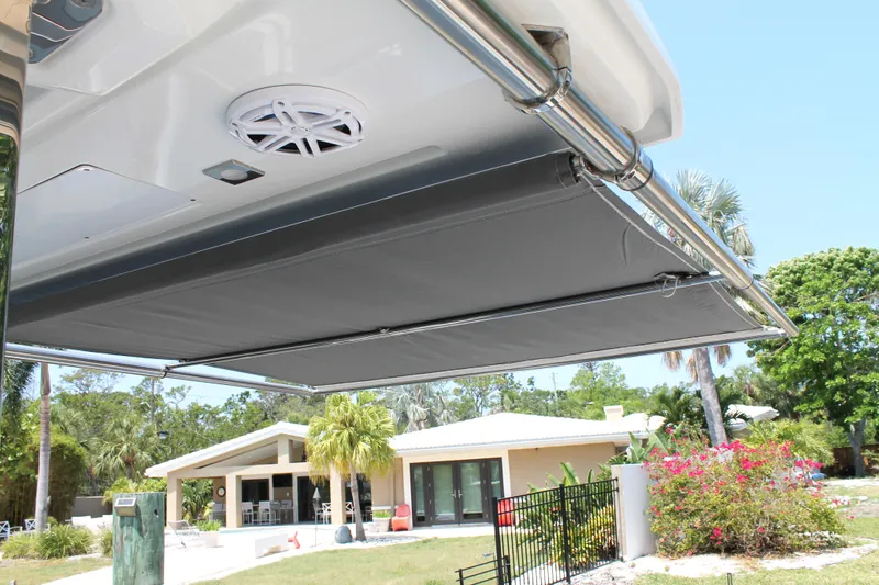 Over Exposed Yacht Photos Pics 2021 Jeanneau Leader 10.5 boat awning, providing shade in a sunny residential setting.