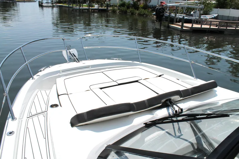 Over Exposed Yacht Photos Pics 2021 Jeanneau Leader 10.5 boat with spacious deck and sunbathing area on calm water.