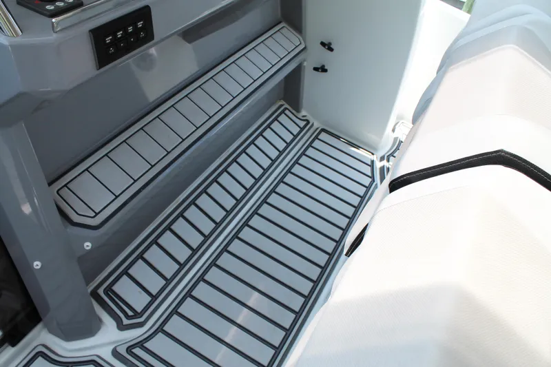 Over Exposed Yacht Photos Pics 2021 Jeanneau Leader 10.5 boat interior with striped flooring and seating.