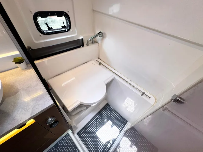 Over Exposed Yacht Photos Pics 2021 Jeanneau Leader 10.5 boat bathroom with compact shower and window.