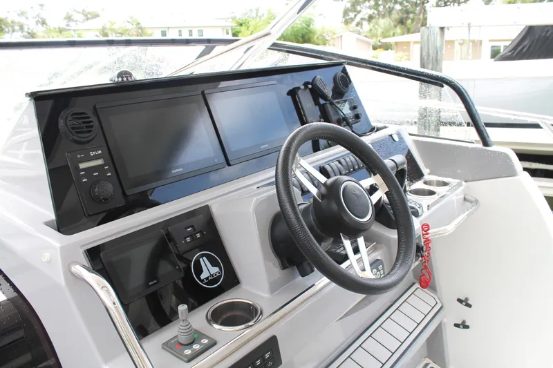 Over Exposed Yacht Photos Pics 2021 Jeanneau Leader 10.5 WA Series 2 helm with modern navigation displays and controls.