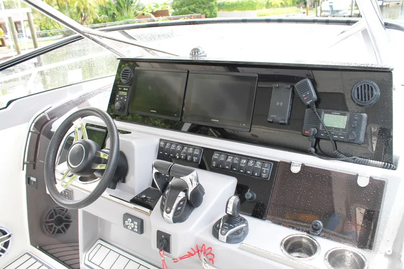 Over Exposed Yacht Photos Pics 2021 Jeanneau Leader 10.5 WA Series 2 helm with modern navigation equipment and controls.