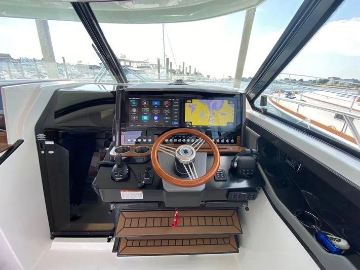  Yacht Photos Pics 2021 Tiara Yachts 43 LE helm with advanced navigation system and wooden steering wheel.