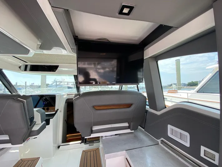  Yacht Photos Pics Interior of 2021 Tiara Yachts 43 LE with modern seating and mounted TV.