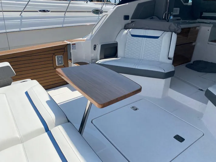  Yacht Photos Pics Luxurious seating area on 2021 Tiara Yachts 43 LE with wooden table and modern design.