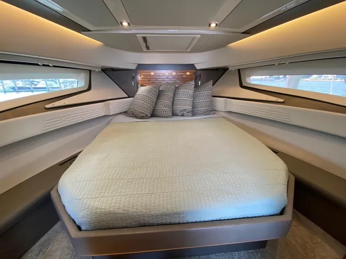  Yacht Photos Pics Luxurious 2021 Tiara Yachts 43 LE cabin interior with elegant bedding and ambient lighting.