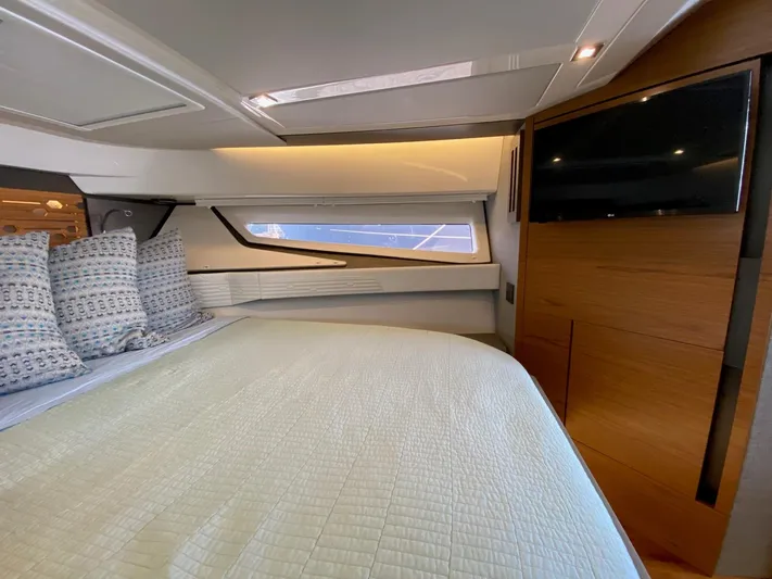  Yacht Photos Pics Luxurious cabin interior of 2021 Tiara Yachts 43 LE with cozy bedding and modern TV.