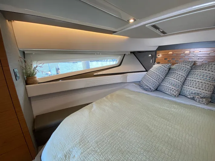  Yacht Photos Pics Luxurious cabin interior of 2021 Tiara Yachts 43 LE with stylish bedding and window view.