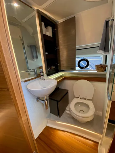  Yacht Photos Pics Luxurious bathroom in 2021 Tiara Yachts 43 LE, featuring modern fixtures and wood accents.
