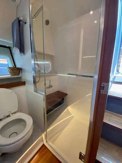  Yacht Photos Pics Luxurious bathroom in 2021 Tiara Yachts 43 LE, featuring shower and toilet.