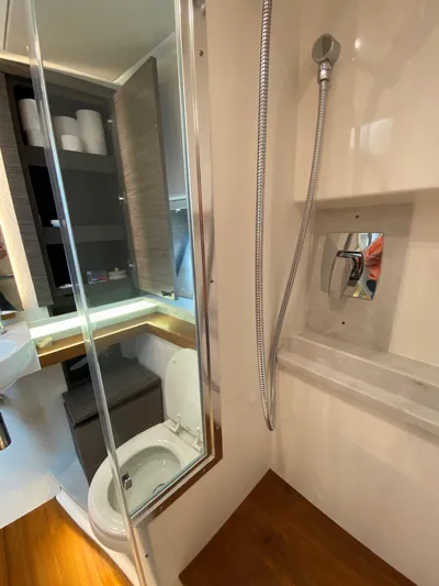  Yacht Photos Pics Luxurious bathroom in 2021 Tiara Yachts 43 LE, featuring modern shower and toilet.