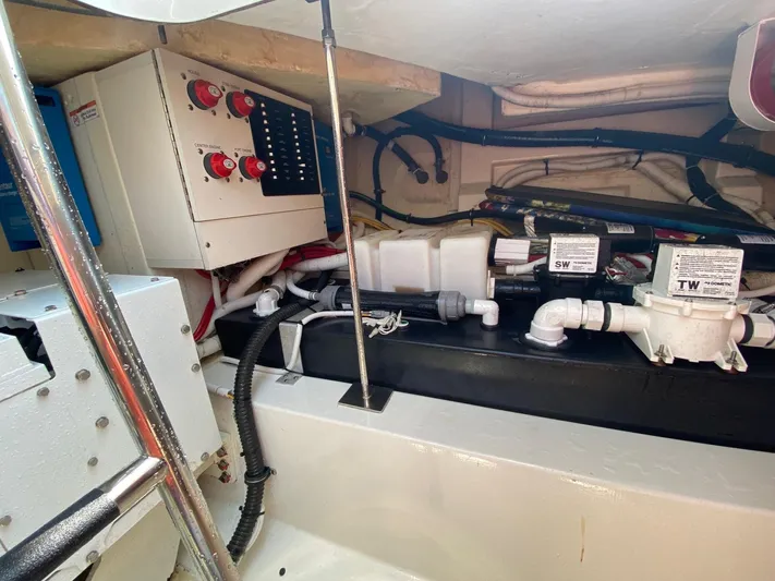  Yacht Photos Pics Engine room of 2021 Tiara Yachts 43 LE with control panel and plumbing.
