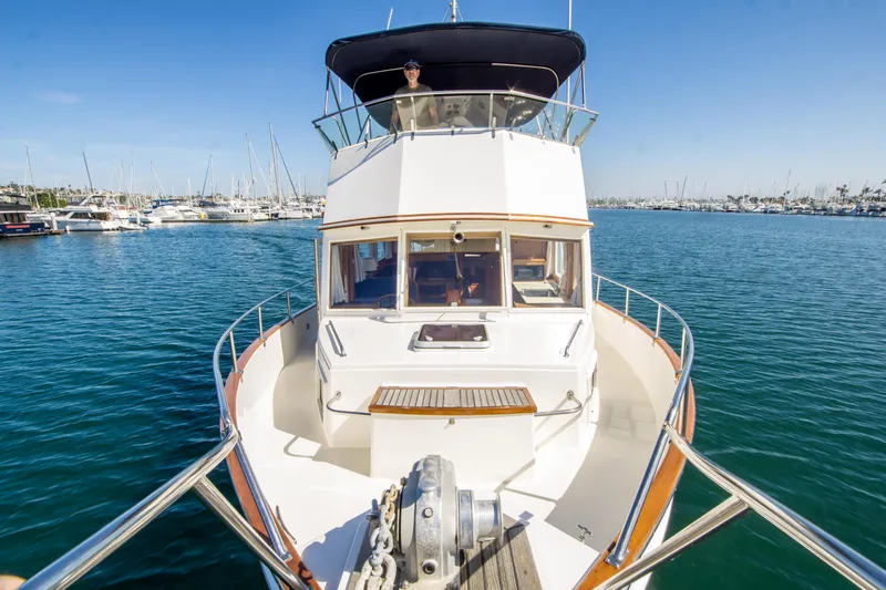 Dauntless Yacht Photos Pics 1995 Grand Banks 42 Classic yacht on calm water, marina background, sunny day.