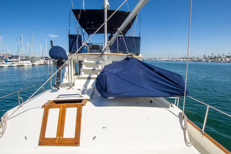 Dauntless Yacht Photos Pics 1995 Grand Banks 42 Classic yacht docked in a marina under clear blue skies.