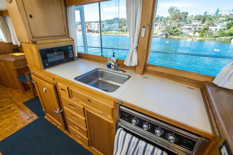 Dauntless Yacht Photos Pics Interior of 1995 Grand Banks 42 Classic yacht kitchen with sink, stove, and microwave.