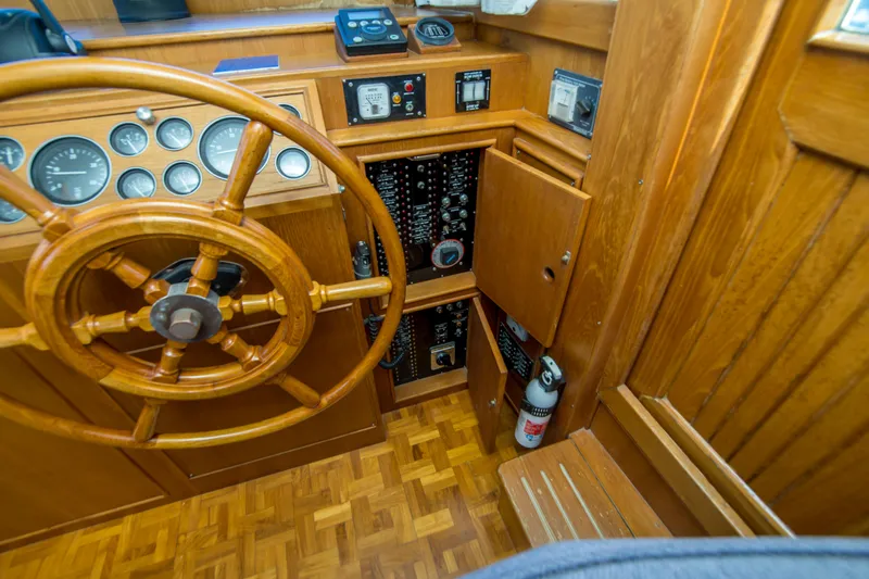 Dauntless Yacht Photos Pics Wooden helm and control panel of 1995 Grand Banks 42 Classic yacht.