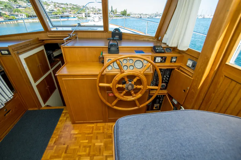 Dauntless Yacht Photos Pics Helm of 1995 Grand Banks 42 Classic yacht with wooden steering wheel and control panel.