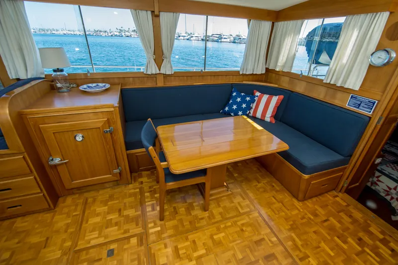 Dauntless Yacht Photos Pics Interior of 1995 Grand Banks 42 Classic yacht with wooden dining area and nautical decor.