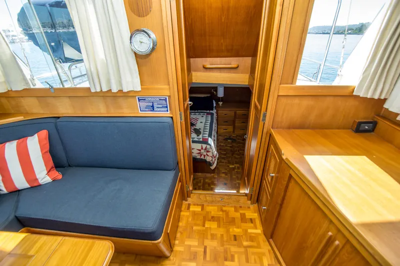 Dauntless Yacht Photos Pics Interior of 1995 Grand Banks 42 Classic yacht with cozy seating and wooden cabinetry.