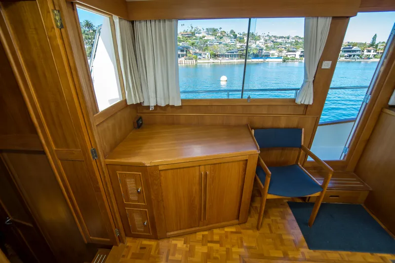 Dauntless Yacht Photos Pics Interior of 1995 Grand Banks 42 Classic yacht with wooden desk and chair, overlooking water.