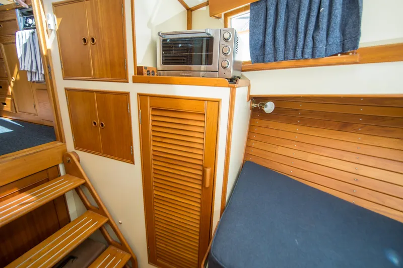 Dauntless Yacht Photos Pics Interior of 1995 Grand Banks 42 Classic yacht with wooden cabinetry and seating.