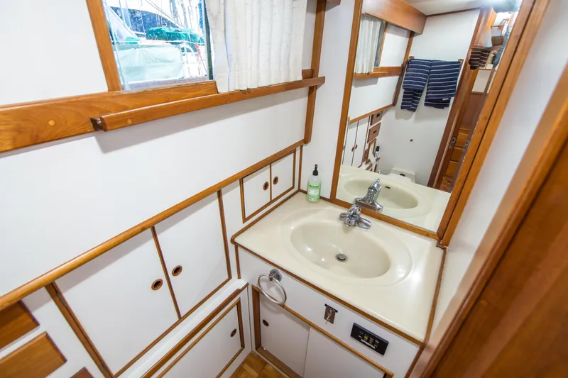 Dauntless Yacht Photos Pics Bathroom interior of 1995 Grand Banks 42 Classic yacht with wooden accents and sink.