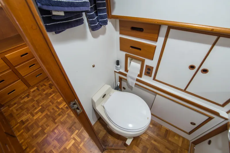 Dauntless Yacht Photos Pics Bathroom interior of 1995 Grand Banks 42 Classic yacht with wooden cabinetry and parquet flooring.