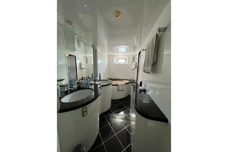  Yacht Photos Pics Luxurious bathroom in 2001 Horizon Elegance 82S yacht with modern fixtures and elegant design.