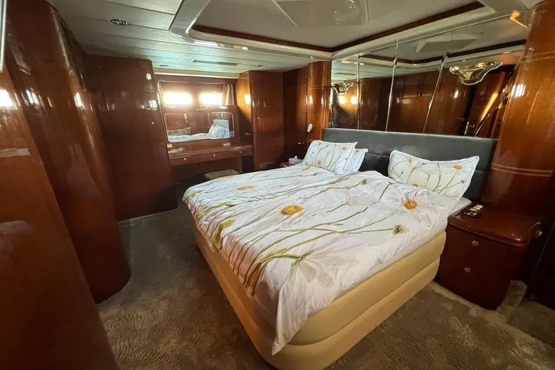  Yacht Photos Pics Luxurious bedroom interior of 2001 Horizon Elegance 82S yacht with elegant wood paneling.