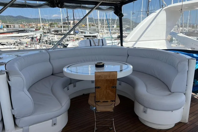  Yacht Photos Pics Luxurious seating area on 2001 Horizon Elegance 82S yacht, docked in a marina.