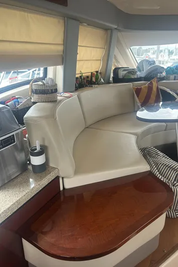  Yacht Photos Pics Interior of 2008 Sea Ray 47 Sedan Bridge with beige seating and wooden accents.