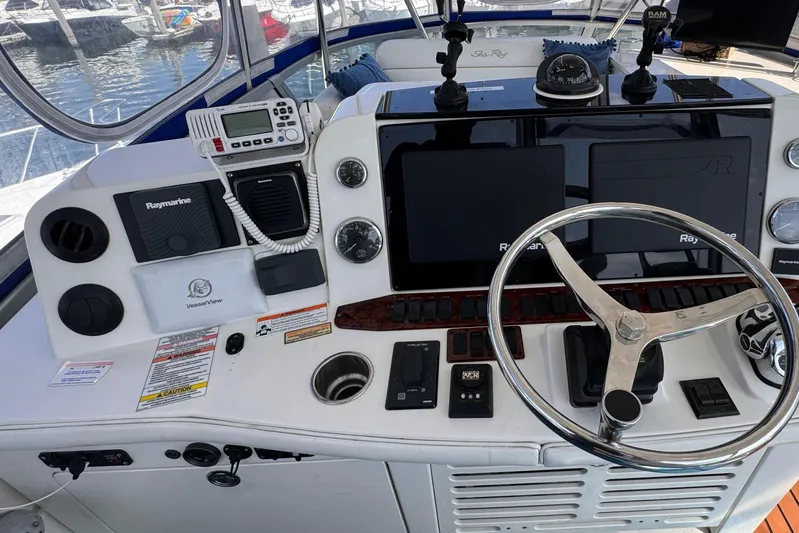  Yacht Photos Pics 2008 Sea Ray 47 Sedan Bridge helm with modern navigation equipment and marina view.