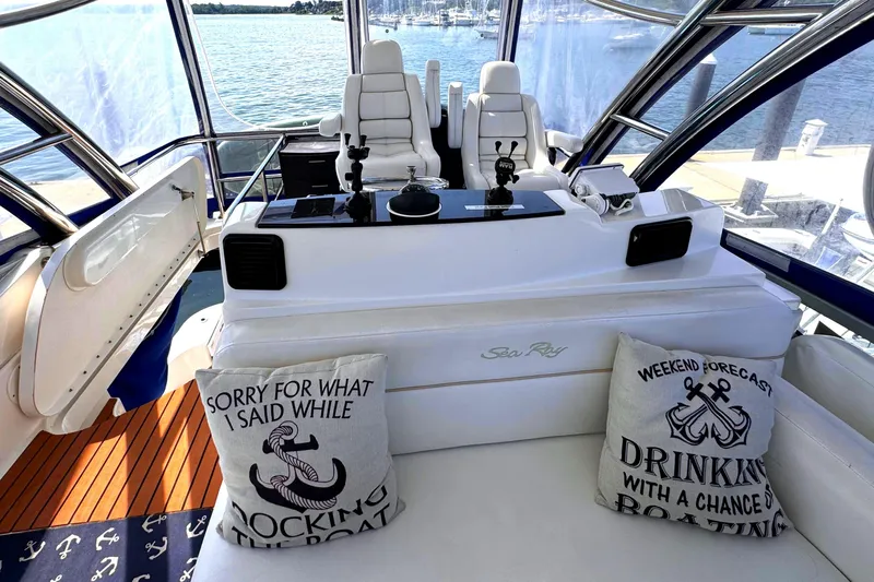  Yacht Photos Pics 2008 Sea Ray 47 Sedan Bridge interior with helm, seating, and nautical-themed pillows.