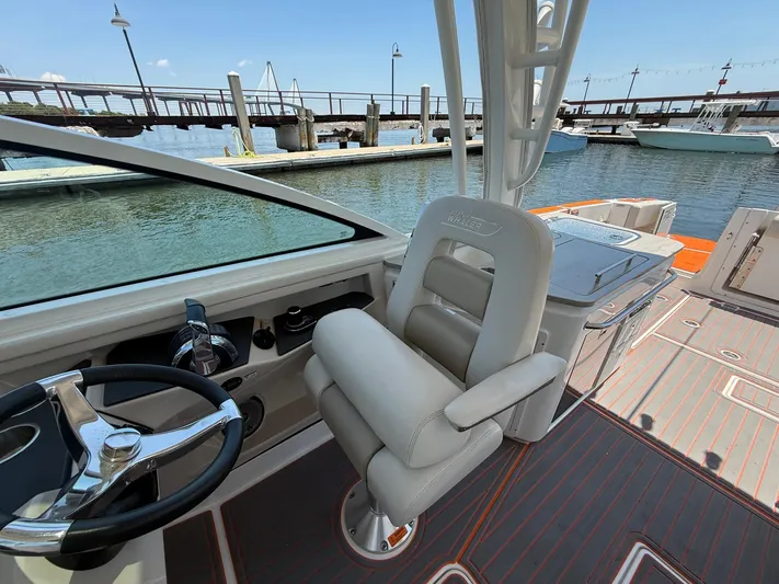  Yacht Photos Pics 2019 Boston Whaler 320 Vantage helm with luxurious seating and waterfront view.