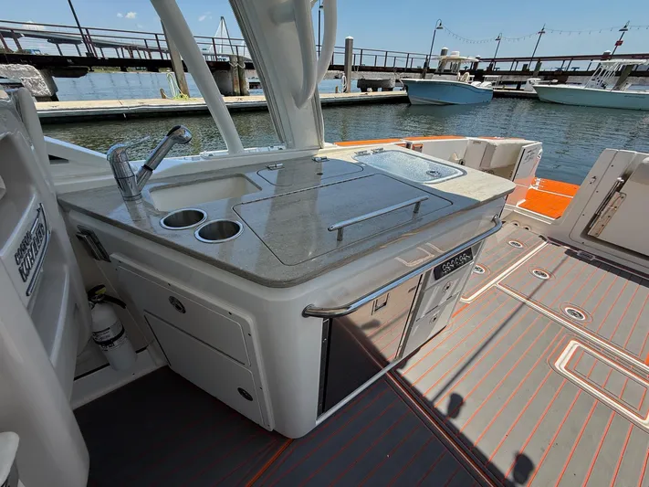  Yacht Photos Pics 2019 Boston Whaler 320 Vantage boat kitchen area with sink and grill at marina.