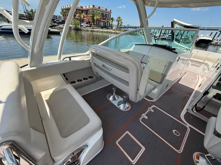  Yacht Photos Pics 2019 Boston Whaler 320 Vantage interior with seating and helm, docked by waterfront.