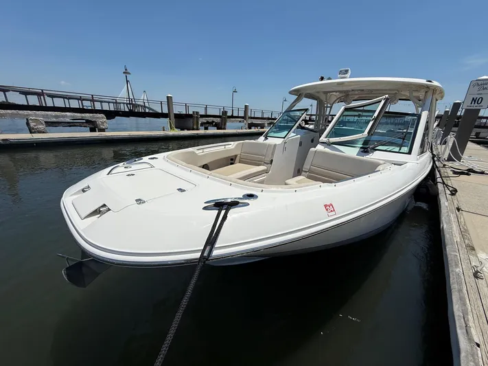  Yacht Photos Pics 2019 Boston Whaler 320 Vantage docked at marina under clear blue sky.