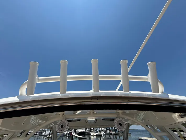  Yacht Photos Pics 2019 Boston Whaler 320 Vantage boat roof with rod holders under clear blue sky.